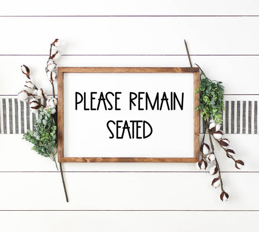 Please Remain Seated Bathroom Sign